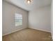 Cozy carpeted bedroom with a window and neutral walls at 24589 Blue Heron Cir, Lancaster, SC 29720