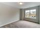 Bright bedroom with carpet flooring and a large window at 6280 Culbert St # 190, Harrisburg, NC 28075