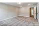 Well-lit bedroom with carpet and hallway access at 6280 Culbert St # 190, Harrisburg, NC 28075