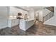 Modern kitchen with white cabinets, island, and stainless steel appliances at 6280 Culbert St # 190, Harrisburg, NC 28075