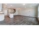 Open concept kitchen and dining area with island and grey flooring at 6280 Culbert St # 190, Harrisburg, NC 28075