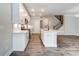 Open concept kitchen with white cabinets and large island at 6280 Culbert St # 190, Harrisburg, NC 28075