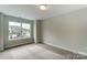 Bright bedroom with neutral walls and carpet flooring at 6280 Culbert St # 190, Harrisburg, NC 28075