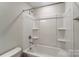 Clean bathroom with tub and shower combo and built-in shelves at 6280 Culbert St # 190, Harrisburg, NC 28075