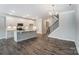 Modern kitchen with white cabinets and an island, open to the living area at 6280 Culbert St # 190, Harrisburg, NC 28075