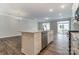 Open concept kitchen with island, stainless steel appliances and hardwood floors at 6280 Culbert St # 190, Harrisburg, NC 28075