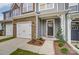 Front entry of townhome with stone accents and landscaping at 6280 Culbert St # 190, Harrisburg, NC 28075