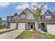 Three-story townhouses available in new community. Features gray siding and stone accents at 6280 Culbert St # 190, Harrisburg, NC 28075