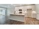 Open concept kitchen with white cabinets, island, and stainless steel appliances at 6280 Culbert St # 190, Harrisburg, NC 28075