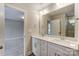Bright bathroom with double vanity and view into bedroom at 6280 Culbert St # 190, Harrisburg, NC 28075