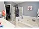 Bathroom with shower, tub, and a walk-in closet at 9841 Baxter Caldwell Dr, Charlotte, NC 28213