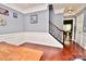 Hardwood floor hallway with stairs and view into dining room at 9841 Baxter Caldwell Dr, Charlotte, NC 28213