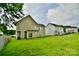 View of backyard with green grass and houses at 9841 Baxter Caldwell Dr, Charlotte, NC 28213