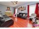Living room features hardwood floors, fireplace, and large windows at 9841 Baxter Caldwell Dr, Charlotte, NC 28213