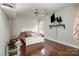 Bright bedroom with wood floors and a ceiling fan at 1820 Oakdale Green Dr, Charlotte, NC 28216