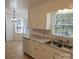 Eat-in kitchen with white cabinets, dual sink, and tile flooring at 2819 Royal Ridge Ln, Charlotte, NC 28212