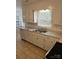 Kitchen with white cabinets, double sink, and tile floor at 2819 Royal Ridge Ln, Charlotte, NC 28212