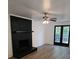 Living room fireplace with black brick and a wood mantel at 2819 Royal Ridge Ln, Charlotte, NC 28212