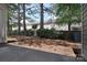 Small, private backyard with pine straw and trees at 12914 Mosby Ln, Charlotte, NC 28273