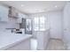 Modern white kitchen with stainless steel appliances and quartz countertops at 12914 Mosby Ln, Charlotte, NC 28273
