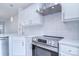 Modern white kitchen with stainless steel appliances and quartz countertops at 12914 Mosby Ln, Charlotte, NC 28273