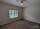 Spacious bedroom with carpeted floors and a large window with plantation shutters at 5916 Meadowmere Dr, Monroe, NC 28110