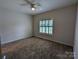 Charming bedroom with carpeted floors and a ceiling fan at 5916 Meadowmere Dr, Monroe, NC 28110