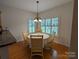 Bright breakfast nook with a round table and four chairs, overlooking the backyard at 5916 Meadowmere Dr, Monroe, NC 28110