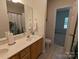 Double vanity bathroom with a large mirror and tiled floor at 5916 Meadowmere Dr, Monroe, NC 28110