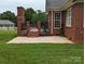 Brick patio with fireplace and seating area, perfect for outdoor entertaining at 5916 Meadowmere Dr, Monroe, NC 28110