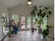 Sunroom with tile floors, large windows, and many plants at 5916 Meadowmere Dr, Monroe, NC 28110