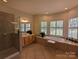 Spa-like bathroom with a corner soaking tub, separate shower, and dual vanities at 5916 Meadowmere Dr, Monroe, NC 28110