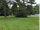 Large grassy backyard with mature trees at 5916 Meadowmere Dr, Monroe, NC 28110