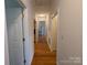 Bright hallway with hardwood floors leading to bedrooms and other rooms at 5916 Meadowmere Dr, Monroe, NC 28110