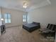 Well-lit bedroom featuring carpeted floors and a ceiling fan at 5916 Meadowmere Dr, Monroe, NC 28110