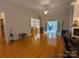 Hardwood floors, fireplace, and views into dining and sunroom areas at 5916 Meadowmere Dr, Monroe, NC 28110