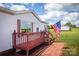 White mobile home with red accents and a wooden deck and walkway at 707 Cool Spring Rd, Statesville, NC 28625