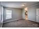 Spacious bedroom with neutral carpeting and access to the bathroom at 707 Cool Spring Rd, Statesville, NC 28625