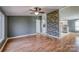 Bright living room with wood-look floors and a decorative stone accent wall at 707 Cool Spring Rd, Statesville, NC 28625
