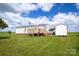 A white mobile home with a wooden deck, carport, and storage shed at 707 Cool Spring Rd, Statesville, NC 28625