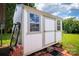 A white and green storage shed with windows, providing additional storage at 707 Cool Spring Rd, Statesville, NC 28625