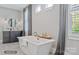 Elegant bathroom with soaking tub, freestanding tub and dark cabinetry at 3314 Lakeside Dr, Charlotte, NC 28270