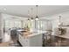 Open concept kitchen with large island, white cabinets and dark hardwood floors at 3314 Lakeside Dr, Charlotte, NC 28270