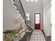 Bright entryway with hardwood floors, red door and staircase at 3314 Lakeside Dr, Charlotte, NC 28270
