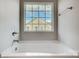 Bathroom with a bathtub and a window at 11507 Valley Oaks Ln, Stanfield, NC 28163