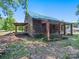 Rustic log cabin with a covered porch and brick pillars at 10910 Archer Rd, Davidson, NC 28036