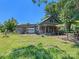 Back view of the house showing a wooden exterior and a detached garage at 10910 Archer Rd, Davidson, NC 28036