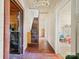 Long hallway with wooden floors and stairs leading upstairs at 10910 Archer Rd, Davidson, NC 28036