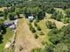 Aerial view of property with cleared land and outbuildings at 10910 Archer Rd, Davidson, NC 28036