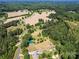 Aerial view of property with large trees and farmlands at 10910 Archer Rd, Davidson, NC 28036